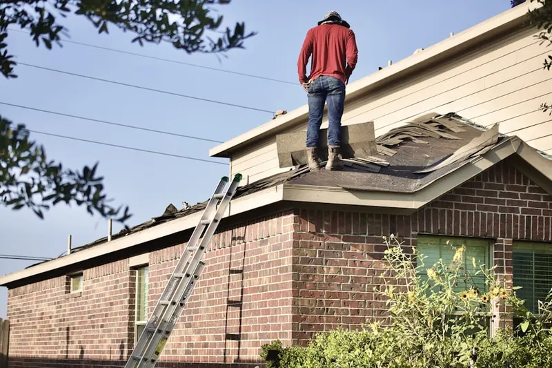 Professional roofer working on a residential roof in Ivoryton